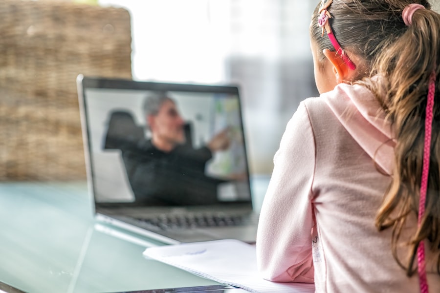 A student attending a class remotely on a laptop from home