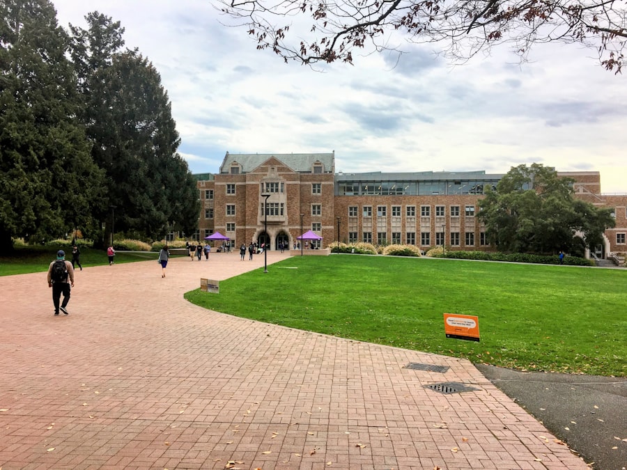 Students walking across a university campus lawn